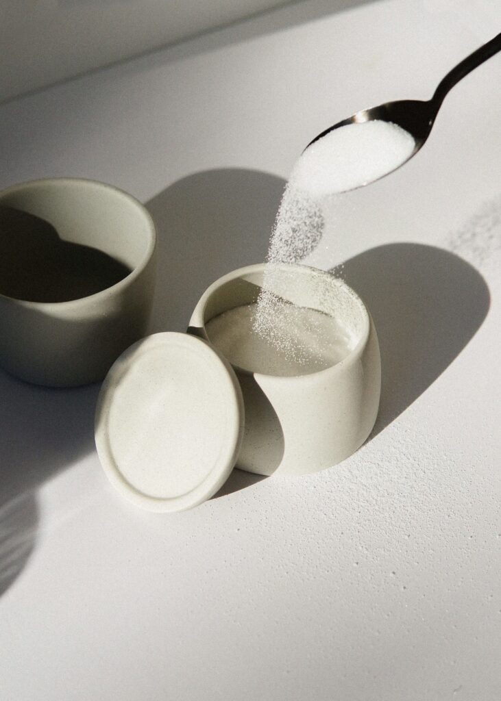 spoonful of sugar poured into a sugar tin